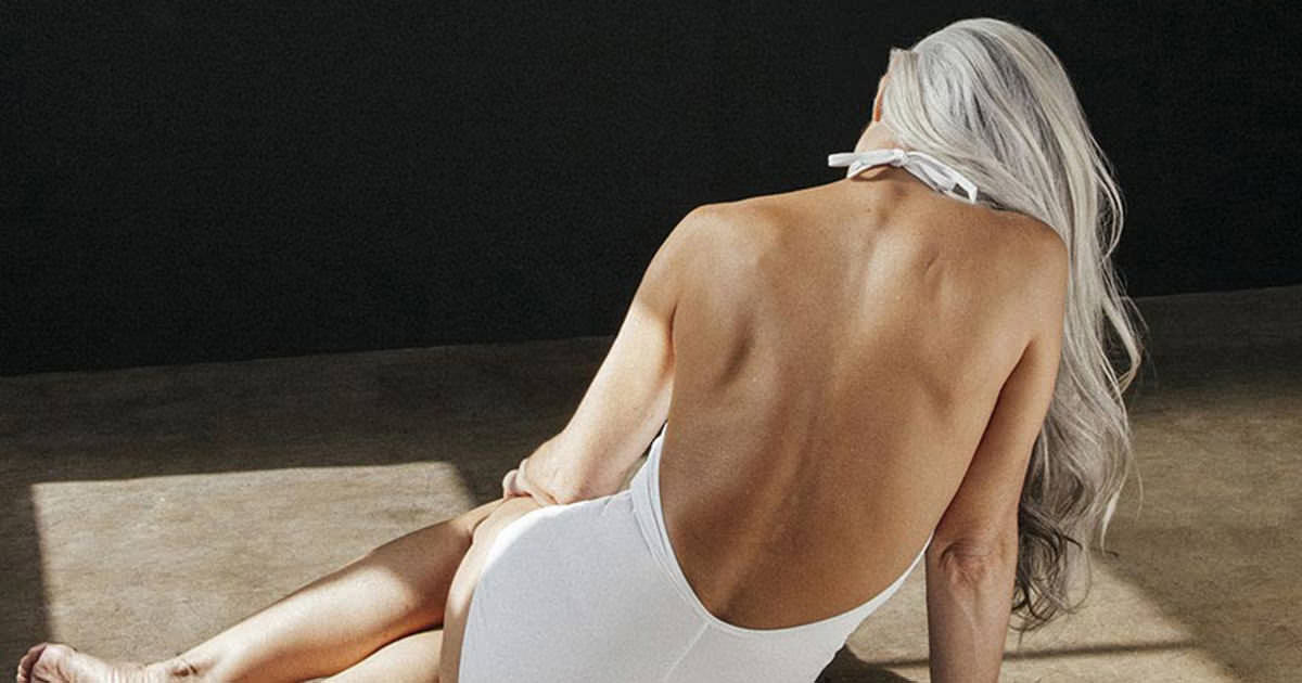 A 61-year-old grandmother looks amazing in her white swimsuit - now watch her turn around